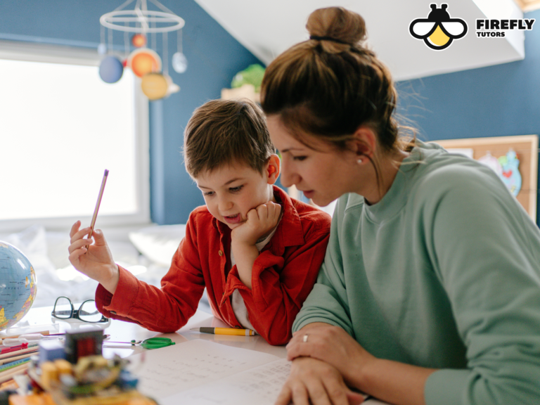 California homeschool mom working one-on-one with her young son at a home learning desk